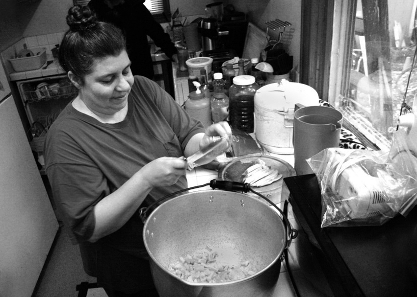 © Mary Anne Funk 2014 Diane Kimes of Anawim Christian Community, prepares a meal for the Anawim Community House meal and church service. Diane Kimes and her husband, Pastor Steve Kimes, have been serving the homeless community and the working poor community since the mid 1990's. Photo by Mary Anne Funk