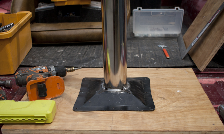 Mark salvaged wood to attach to the leg bases. The base and the wood will be attached to the bottom of each handcrafted tile game table he made. Design by Mark Funk.Photo by Mary Anne Funk